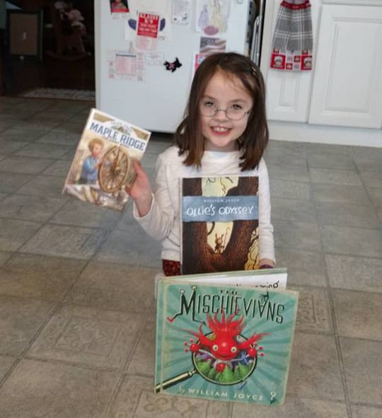 Big reader smiling with Picture books and Easy readers