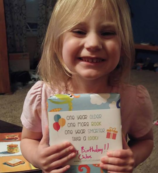 Best birthday gift ever - a smiling kid with Little Fun Club Books